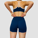 Stella – ensemble short brassière contrasté OraFit, coloris bleu marine vue de dos [partagée avec Stella - Short contrasté et Stella - Brassière contrastée]